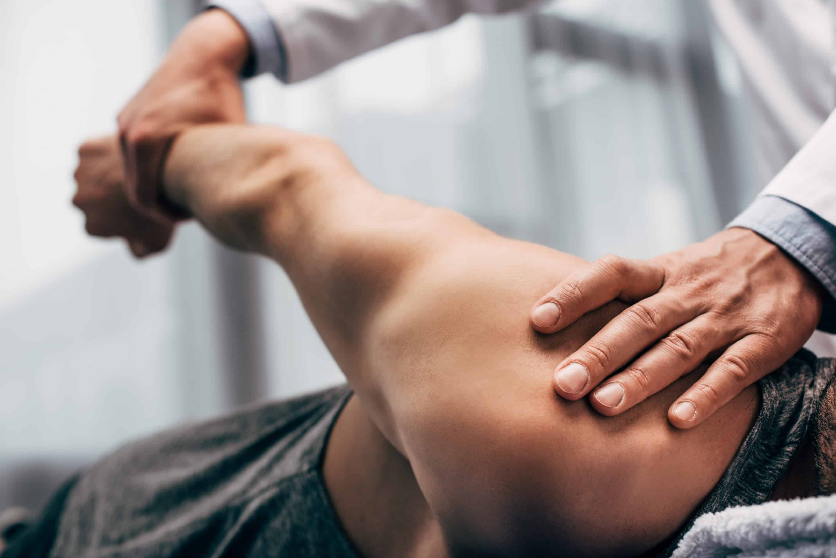 Chiropractor performing stretching of a patient arm